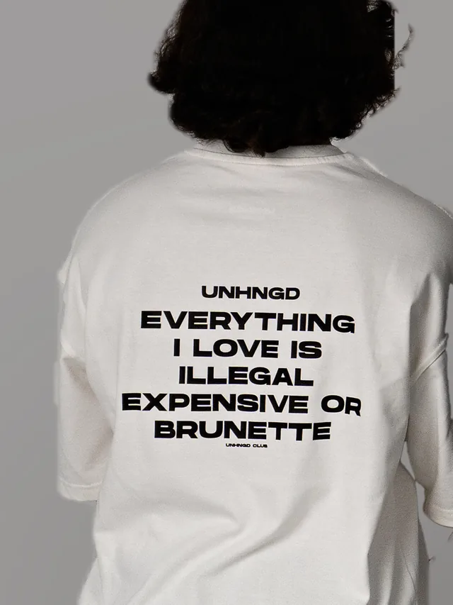 The ‘Everything I love is illegal, expensive or brunette’ print on the back of a white tee.